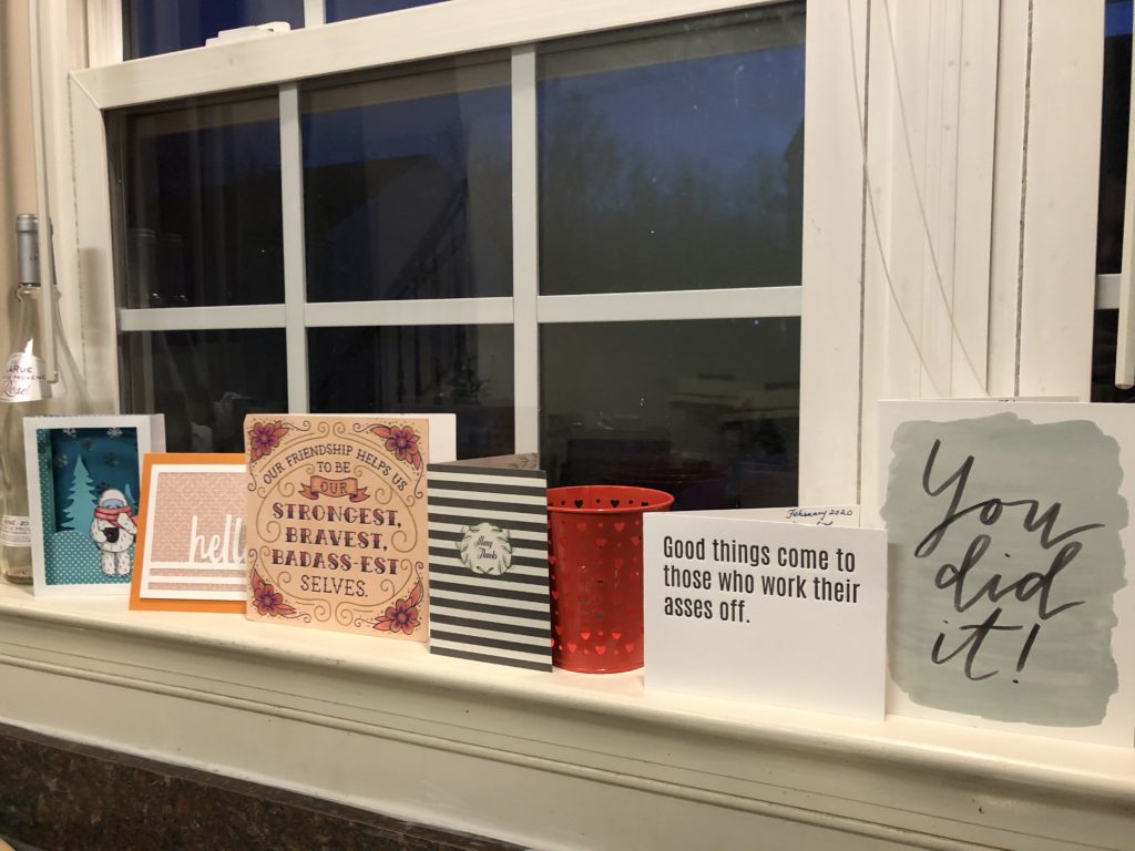 a line of inspirational cards propped on a window sill