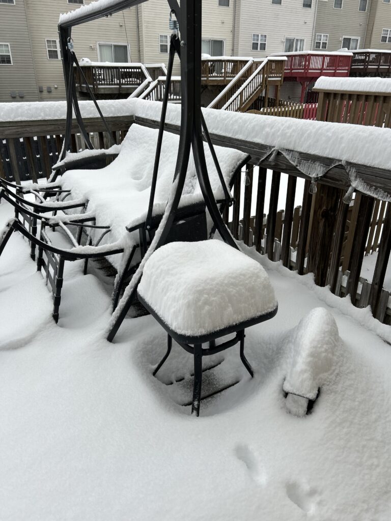 6-8 inches of snow on the deck and deck furniture.