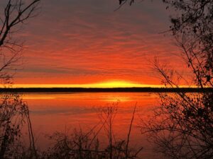 Sunrise over the Potomac River - a blood red sky reflected on the river with a thin yellow line cresting the horizon