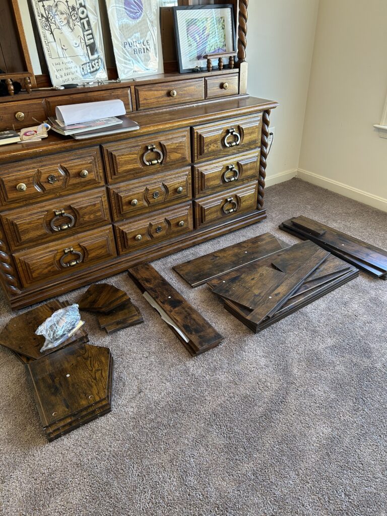 Laid out pieces of a book case waiting to be assembled. 